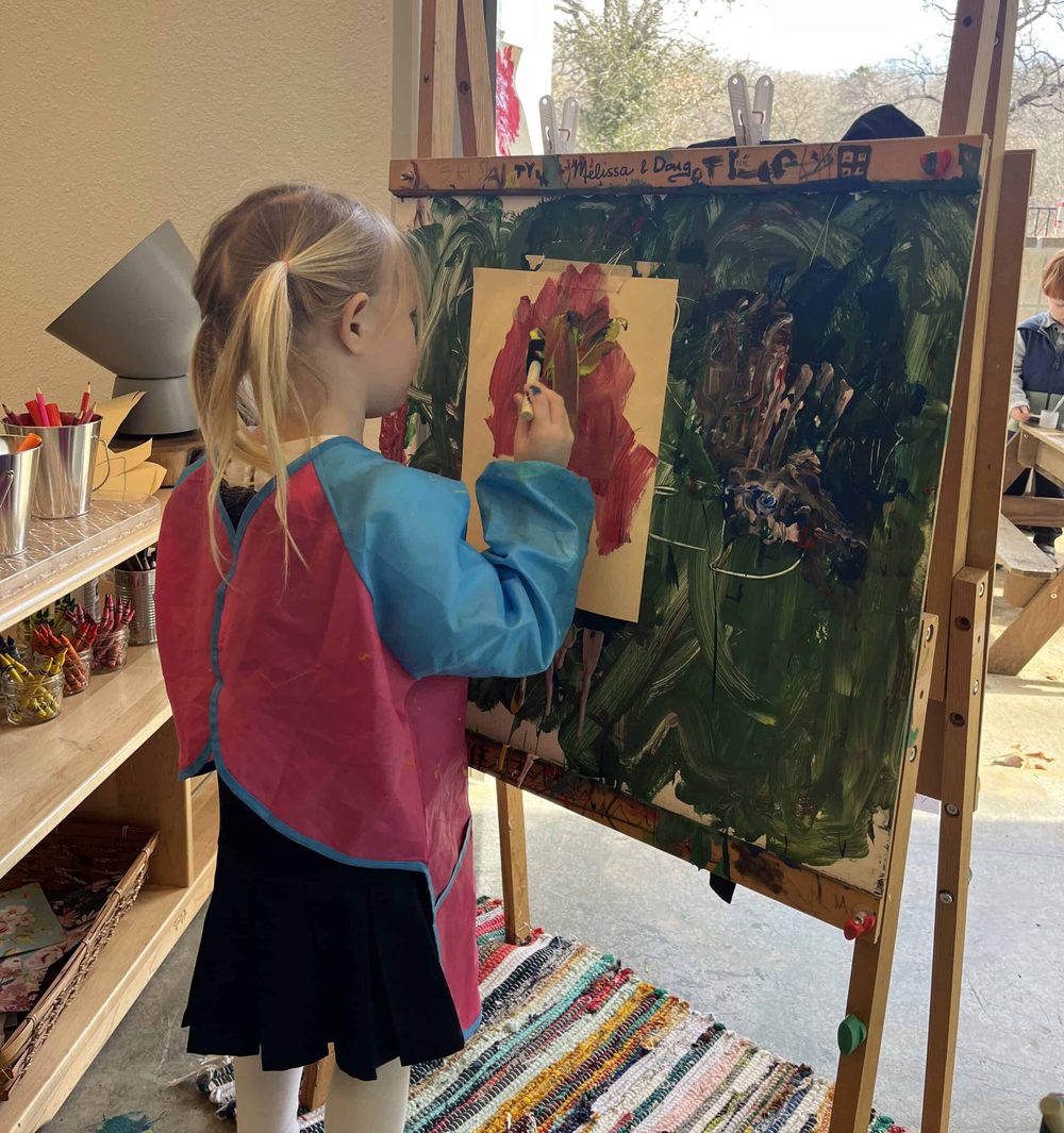 A Selwyn student painting at an easel in the art studio