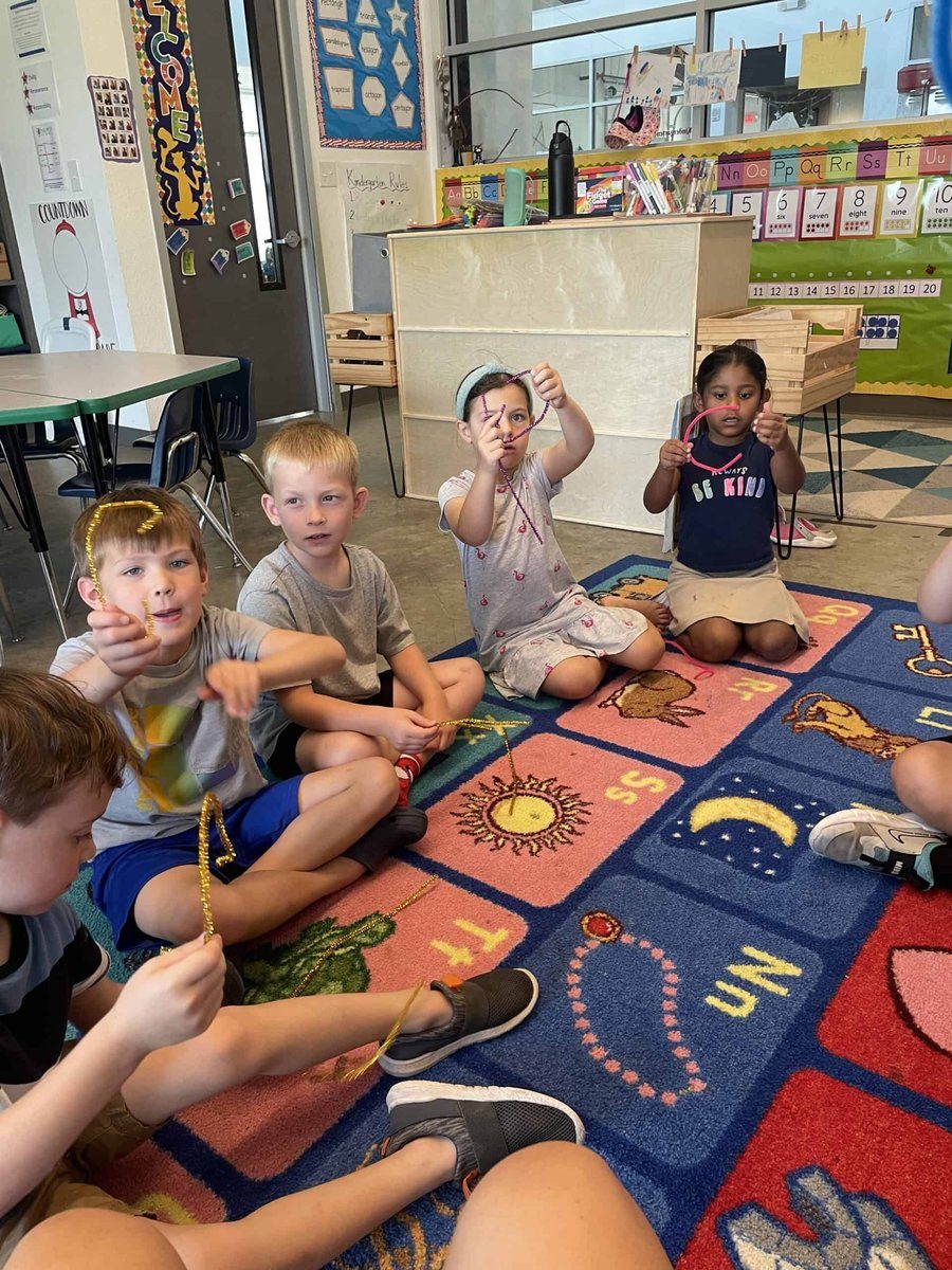 Selwyn preschool students sitting together on a classroom rug