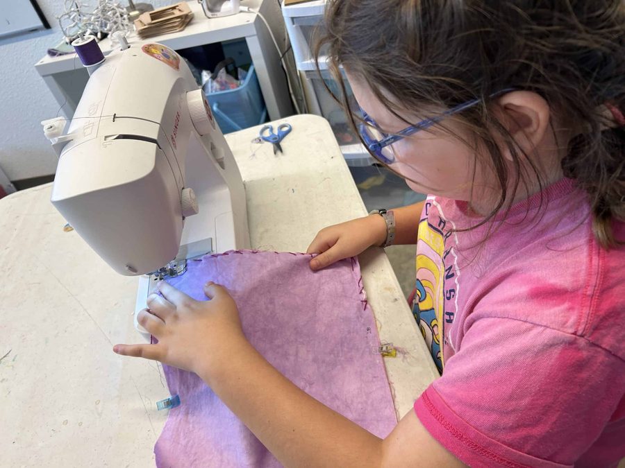 A Selwyn student working at a sewing machine