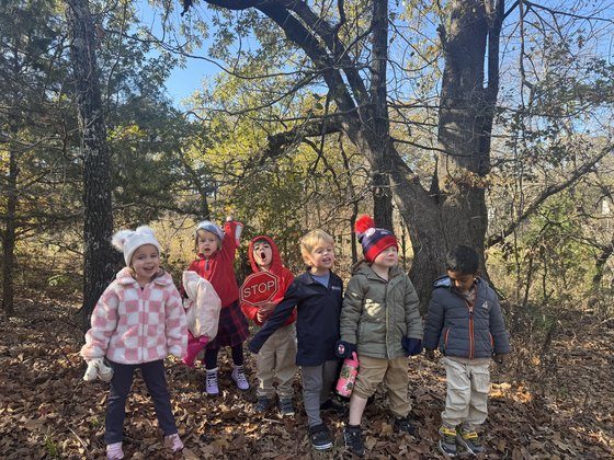 Selwyn students walking together in the woods on campus